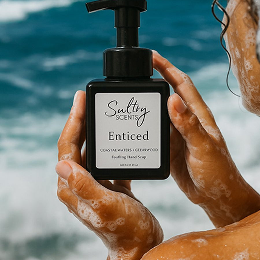 Person lathering luxury foaming hand soap on hands at a sink for a clean and fragrant experience