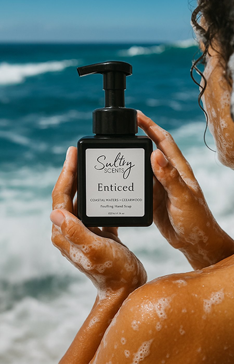 Person lathering luxury foaming hand soap on hands at a sink for a clean and fragrant experience