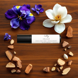 Sultry Scents roll on fragrance oil on wood with magnolia and iris petals and sandalwood Mojave Ghost dupe roll on perfume