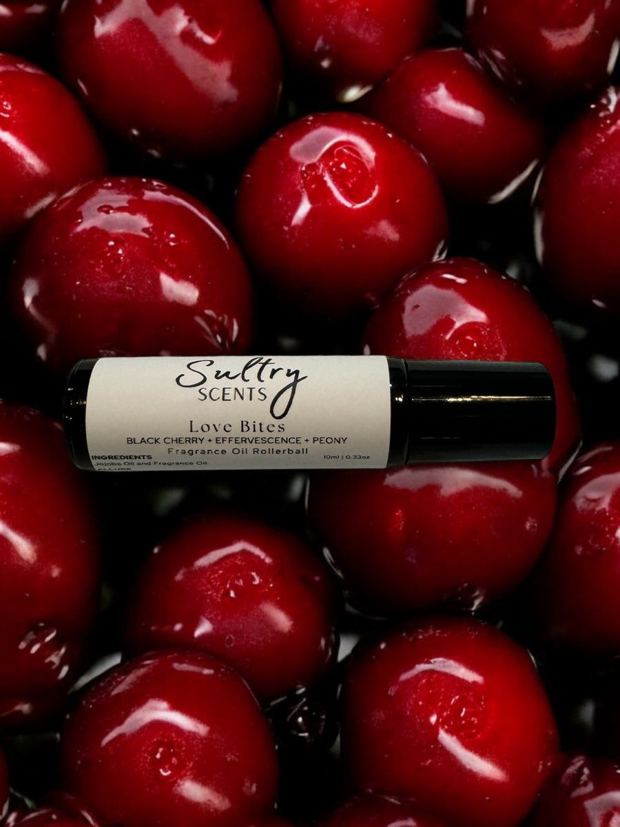 Sultry Scents Black cherry roll on perfume fragrance oil bottle surrounded by fresh cherries
