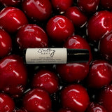 Sultry Scents Black cherry roll on perfume fragrance oil bottle surrounded by fresh cherries