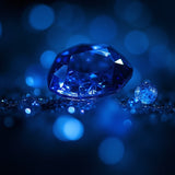 Blue sparkling gemstone surrounded by smaller shiny blue gems symbolizing Bleu de Chanel dupe roll on perfume