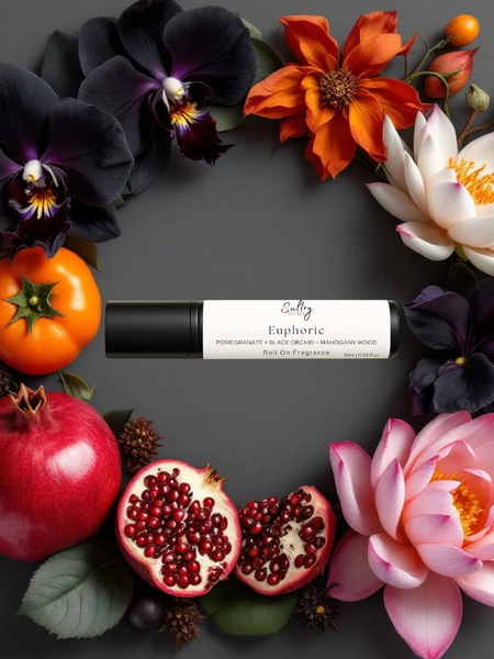 Euphoric roll on perfume inspired by CK Euphoria, surrounded by vibrant flowers and fruits
