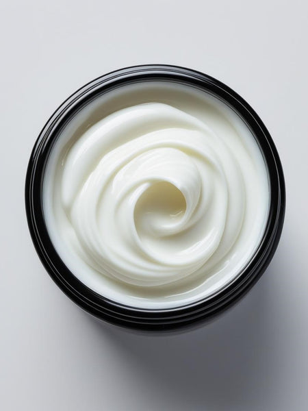 Open container showing smooth white goat milk body cream with creamy texture by Sultry Scents