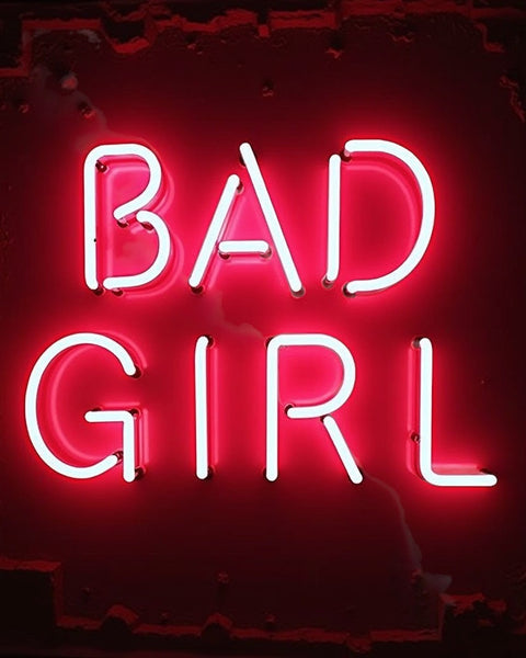Neon sign glowing pink red spelling Bad Girl for Good Girl Perfume dupe Body Spray branding