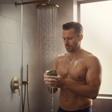 Man using handcrafted KC Roasterie coffee soap in a modern shower for a refreshing cleanse