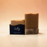 Two bars of Sultry Scents handcrafted turmeric soap made with tallow in natural light