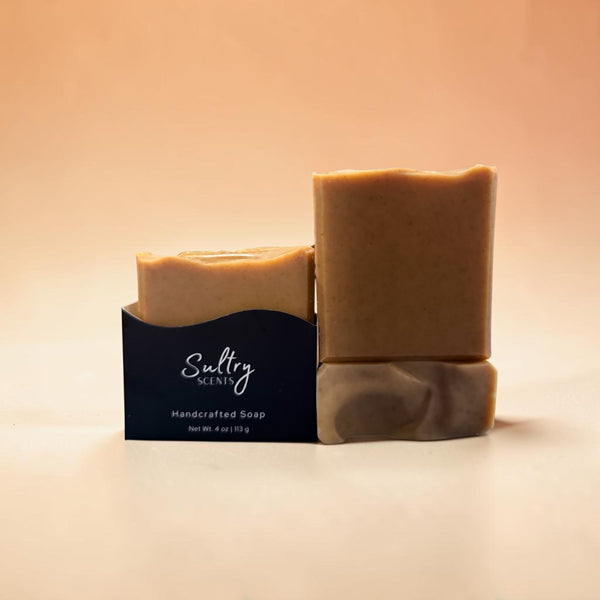 Two bars of Sultry Scents handcrafted turmeric soap made with tallow in natural light