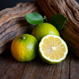 Fresh limes and wood background representing Jo Malone Oud Bergamot dupe body spray fragrance notes
