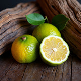 Fresh bergamot fruit with green leaves on wooden surface representing Jo Malone Oud Bergamot dupe roll on perfume scent