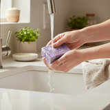 Person using Lavender Chamomile Handcrafted Soap under running water in a modern kitchen sink