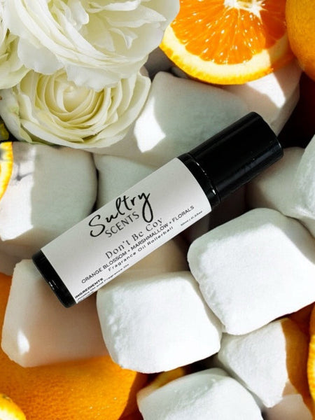 Sultry Scents Love dont be shy dupe roll on perfume with white roses and orange slices background