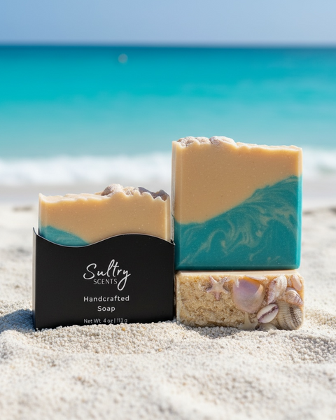 Luxury beach soap bar by Sultry Scents with ocean-inspired colors and natural shell accents located on a sand beach with turquoise water.