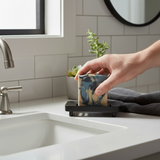 Mens soap inspired by YSL Myslf displayed on a modern bathroom sink with a hand holding it