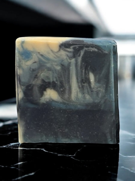 Mens soap inspired by YSL Myslf with black and beige marbled design on dark surface