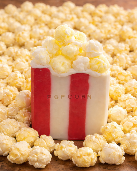 Novelty Popcorn Soap Bar with realistic popcorn topping, surrounded by popcorn kernels for a playful touch
