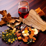 Glass of red wine with dried fruits and flowers artfully arranged for Sultry Scents red wine perfume soap