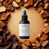 Sultry Scents Santal 26 inspired Body Spray in a sleek black bottle surrounded by wood textures