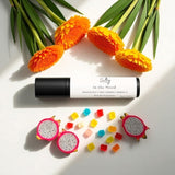 Sultry Scents In the Mood roll on fragrance with colorful gummies, marigold flowers, and dragon fruit slices Phlur mood ring dupe roll on fragrance