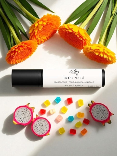 Sultry Scents In the Mood roll on fragrance with colorful gummies, marigold flowers, and dragon fruit slices Phlur mood ring dupe roll on fragrance