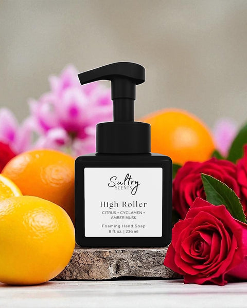 Sultry Scents High Roller black pump bottle surrounded by citrus, cyclamen, and red roses Caesars Palace inspired foaming hand soap