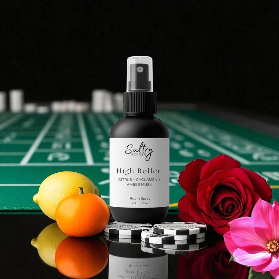 Sultry Scents High Roller room spray bottle on casino table with chips lemon, orange, cyclamen and rose Caesars Palace inspired room spray