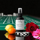 Sultry Scents High Roller room spray bottle on casino table with chips lemon, orange, cyclamen and rose Caesars Palace inspired room spray