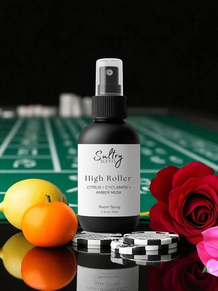 Sultry Scents High Roller room spray bottle on casino table with chips lemon, orange, cyclamen and rose Caesars Palace inspired room spray