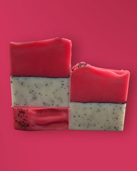 Sultry Scents Dragon Fruit Soap Bar with pink and white layers and black seeds on pink background