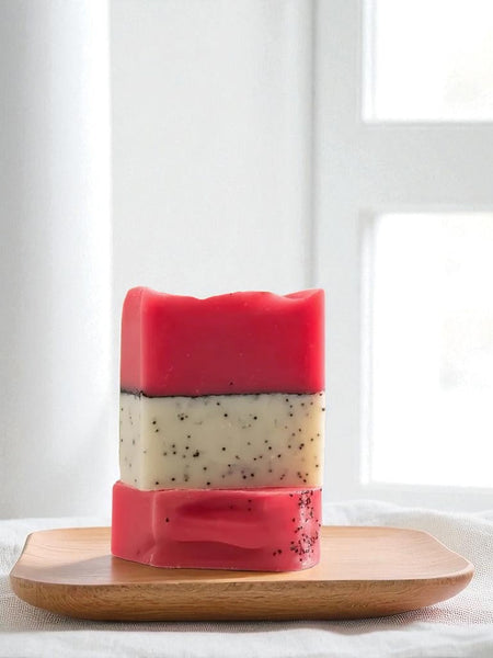Sultry Scents Dragon Fruit Soap Bar with hot pink and white layers featuring natural exfoliating seeds on wooden tray