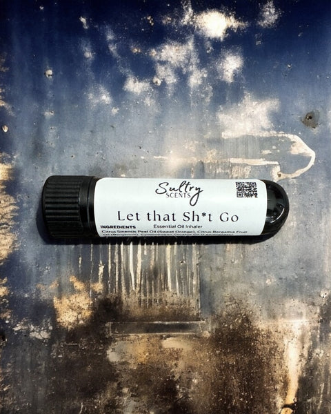 Sultry Scents Let that Sh*t Go Essential Oil Inhaler with black cap on textured surface
