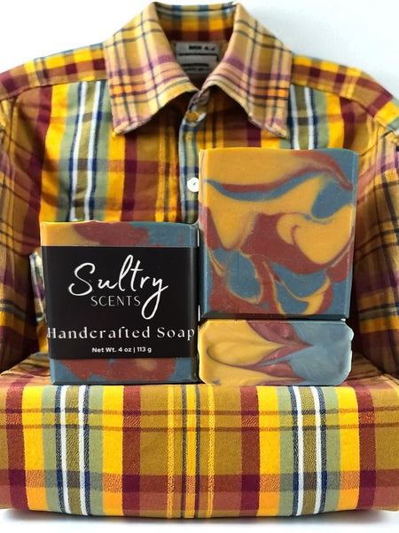Fall Flannel Soap Bar displayed next to a cozy plaid shirt, emphasizing its handcrafted elegance