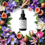 Sultry Scents Father Figure inspired body spray surrounded by vibrant floral decorations