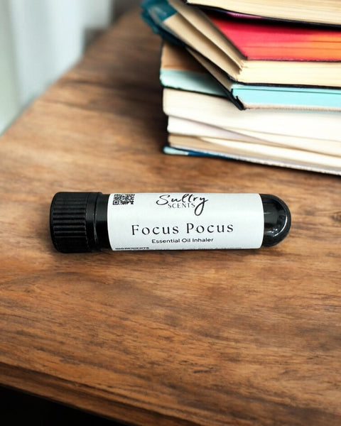 Sultry Scents Focus Pocus focus essential oil inhaler on wooden table near stacked books