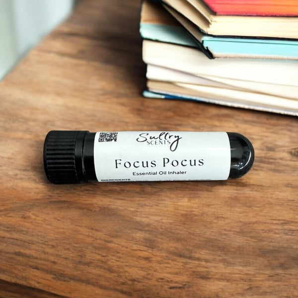 Sultry Scents Focus Pocus focus essential oil inhaler on wooden table near stacked books