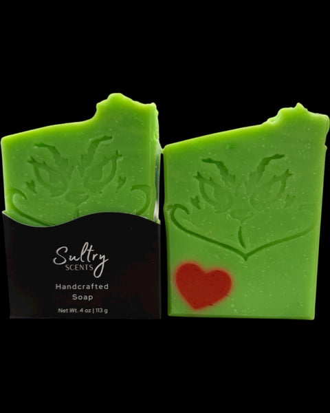 Holiday Grump soap bar by Sultry Scents, vibrant green with Grinch face and red heart