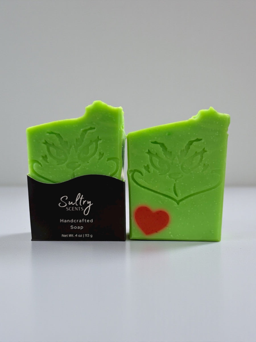 Sultry Scents Holiday Grump soap bar in green with Grinch face and heart detail
