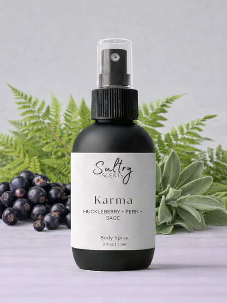 Sultry Scents Huckleberry body spray in a sleek bottle with fern and sage background