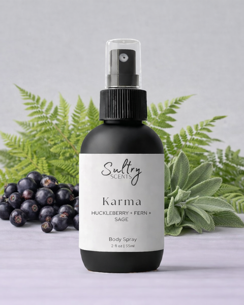 Sultry Scents Huckleberry body spray in a sleek bottle with fern and sage background