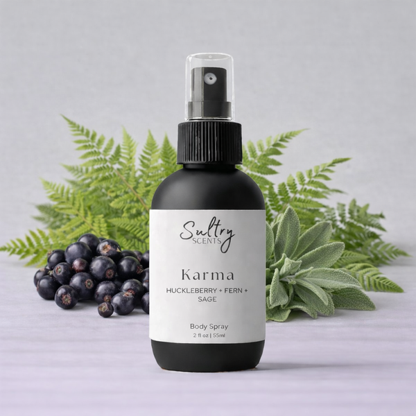Sultry Scents Huckleberry body spray in a sleek bottle with fern and sage background