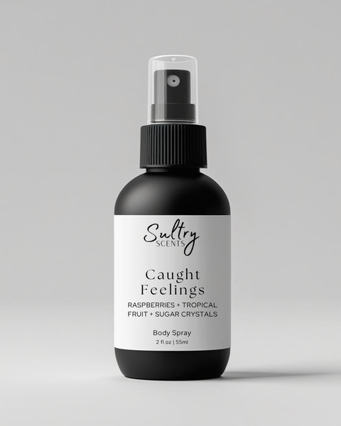 Sultry Scents Caught Feelings Body Spray with scent notes Raspberries and Tropical Fruit, in love with everything inspired perfume. Shows a 2 oz black bottle with white label.