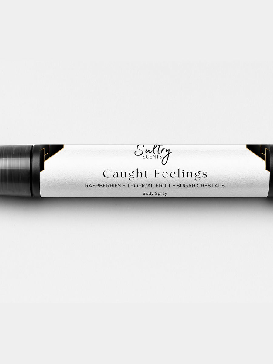 Sultry Scents Caught Feelings Body Spray with Raspberries, Tropical Fruit, and Sugar Crystals, In love with everything inspired perfume. Shows a 10 mL travel size spray bottle.