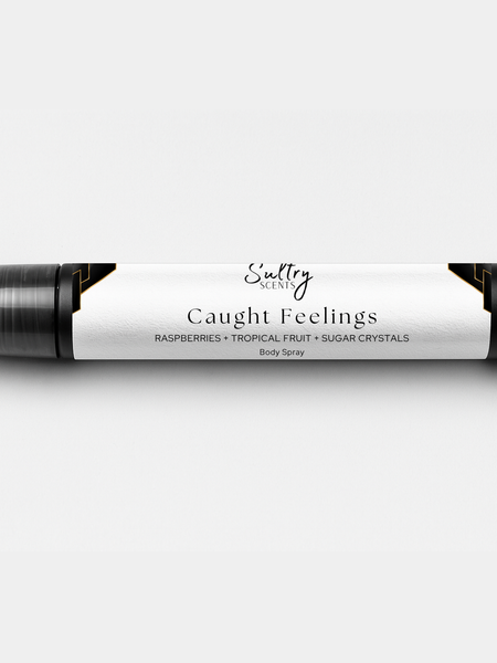 Sultry Scents Caught Feelings Body Spray with Raspberries, Tropical Fruit, and Sugar Crystals, In love with everything inspired perfume. Shows a 10 mL travel size spray bottle.