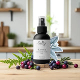 Sultry Scents Karma Huckleberry body spray bottle with natural berries and leaves on wooden surface