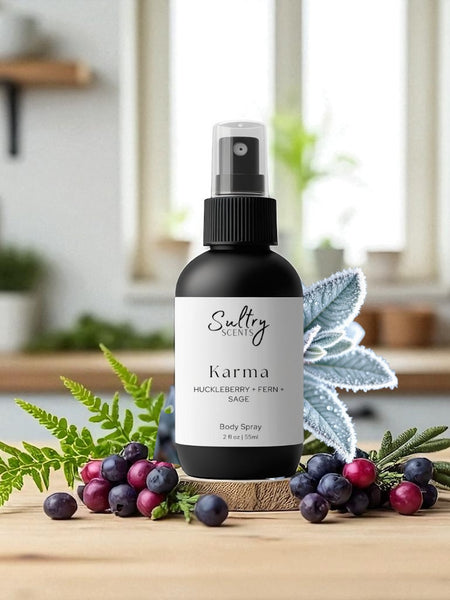 Sultry Scents Karma Huckleberry body spray bottle with natural berries and leaves on wooden surface
