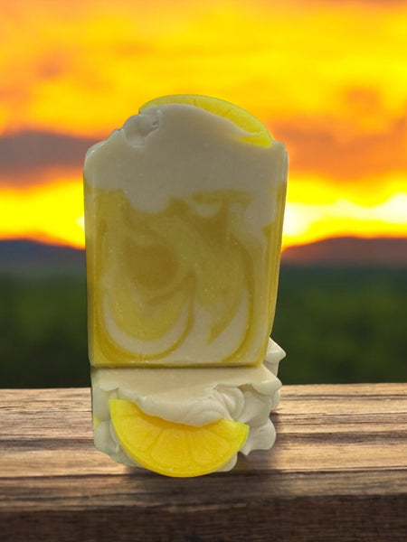 Lemon scented soap bar with a vibrant yellow design and lemon slice detail on a wooden surface