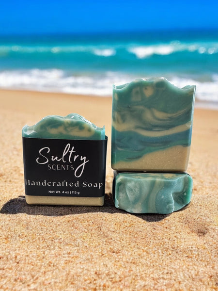 Sultry Scents luxury beach soap bar with a beautiful ocean swirl design on a sandy beach