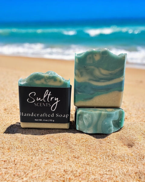 Sultry Scents luxury beach soap bar with a beautiful ocean swirl design on a sandy beach