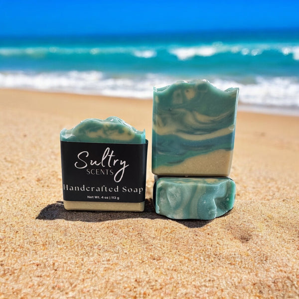 Sultry Scents luxury beach soap bar with a beautiful ocean swirl design on a sandy beach