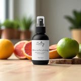 Sultry Scents luxury body spray citrus and sandalwood with bergamot in black spray bottle on wooden surface